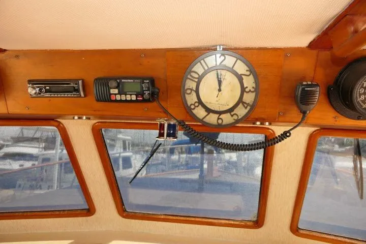 Slide: The Image of Interior of 1983 CHB 45 boat with clock, radio, and windows overlooking marina. - 40