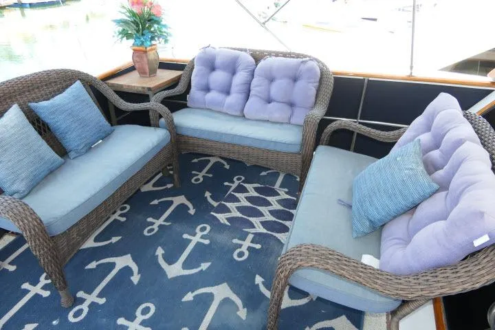 Slide: The Image of Wicker seating with blue cushions on a CHB 45 yacht, featuring an anchor-themed rug. - 43