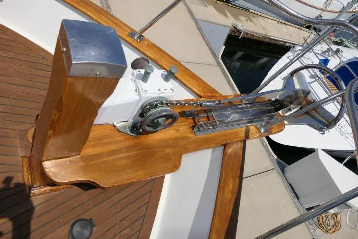 Slide: The Image of Wooden deck of 1983 CHB 45 boat with anchor chain mechanism. - 52