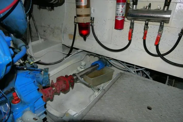 Slide: The Image of Engine room of a 1983 CHB 45 boat, featuring mechanical components and fire safety equipment. - 65
