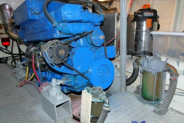 Slide: The Image of Engine room of 1983 CHB 45 boat with blue engine and mechanical components. - 67