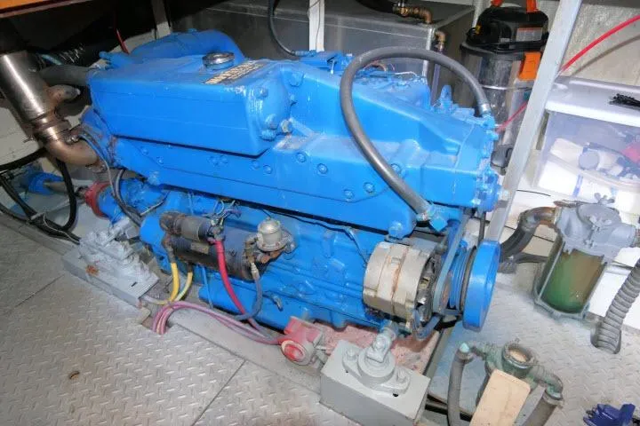 Slide: The Image of Blue engine in a 1983 CHB 45 boat, detailed view of mechanical components. - 68