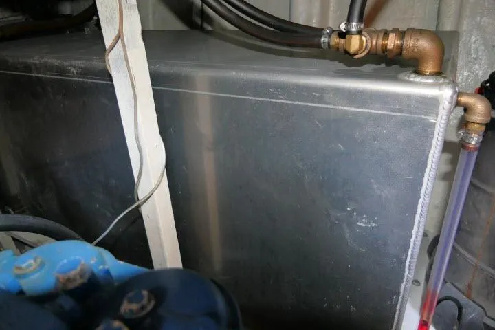 Slide: The Image of Engine compartment of a 1983 CHB 45 boat, showing metal tank and hoses. - 70