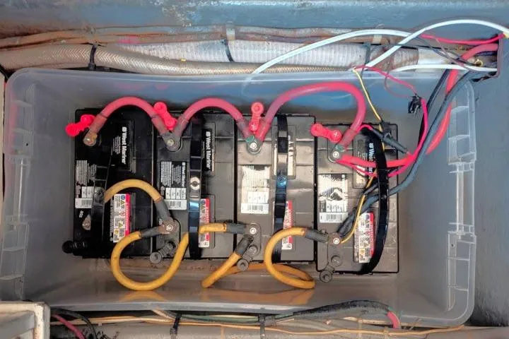 Slide: The Image of Battery setup in a 1983 CHB 45 model, featuring connected cables and wiring. - 74