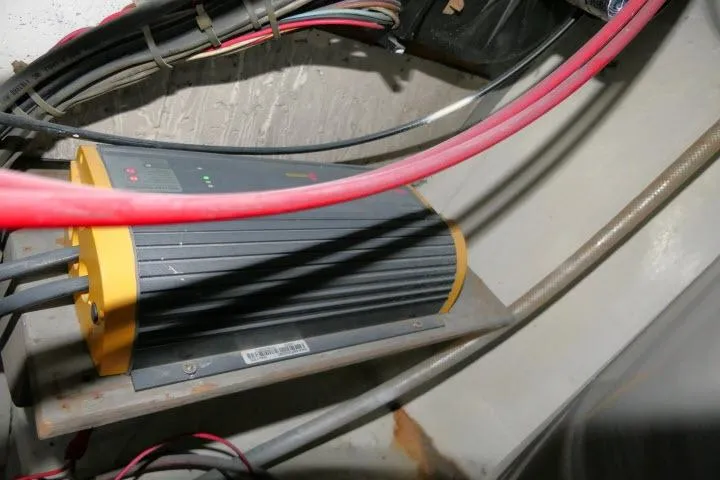 Slide: The Image of Electrical equipment in a 1983 CHB 45 boat, featuring cables and a power unit. - 76