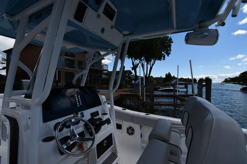 Slide: The Image of 2022 Sea Fox 268 Commander boat interior with waterfront view, featuring helm and seating. - 15