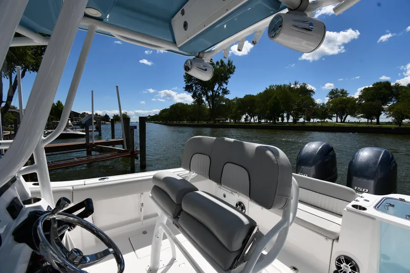 Slide: The Image of 2022 Sea Fox 268 Commander boat interior with dual engines, docked by a scenic river. - 20