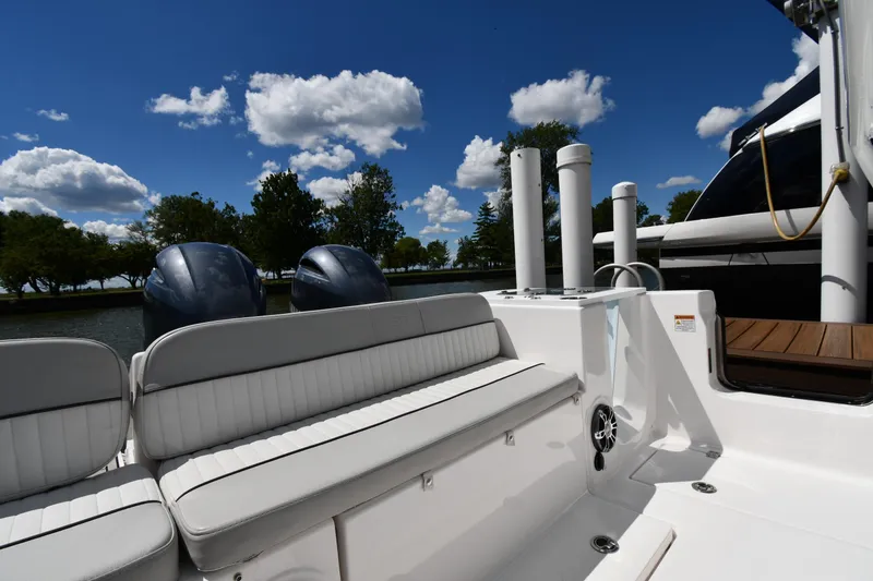 Slide: The Image of 2022 Sea Fox 268 Commander boat interior with seating, engines, and clear blue sky. - 23
