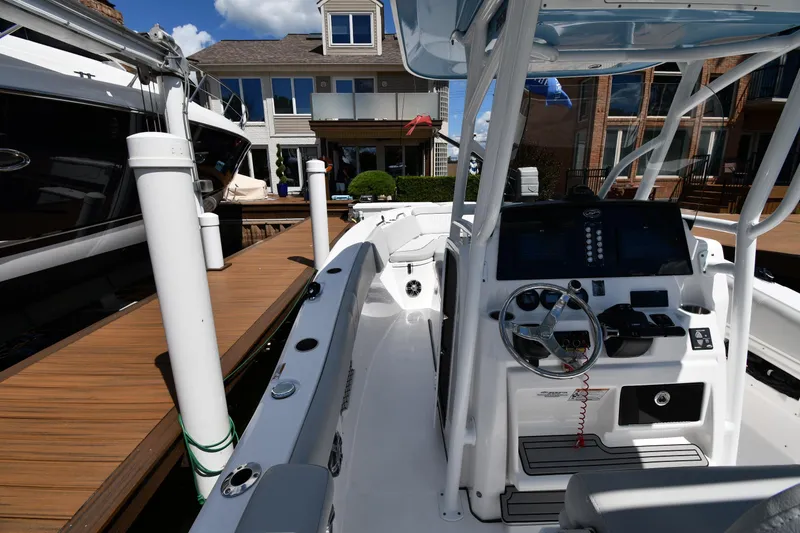 Slide: The Image of 2022 Sea Fox 268 Commander boat docked, showcasing helm and interior features. - 30