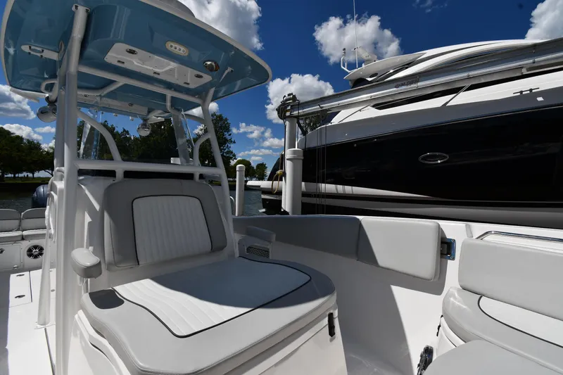 Slide: The Image of 2022 Sea Fox 268 Commander boat interior with seating, under a blue sky. - 33