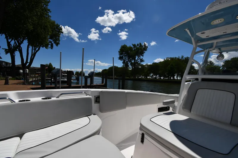 Slide: The Image of 2022 Sea Fox 268 Commander boat interior with seating, dockside view, and clear blue sky. - 34