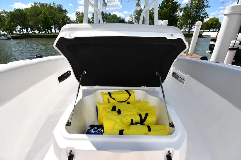 Slide: The Image of Open storage compartment on 2022 Sea Fox 268 Commander boat with yellow life jackets. - 36
