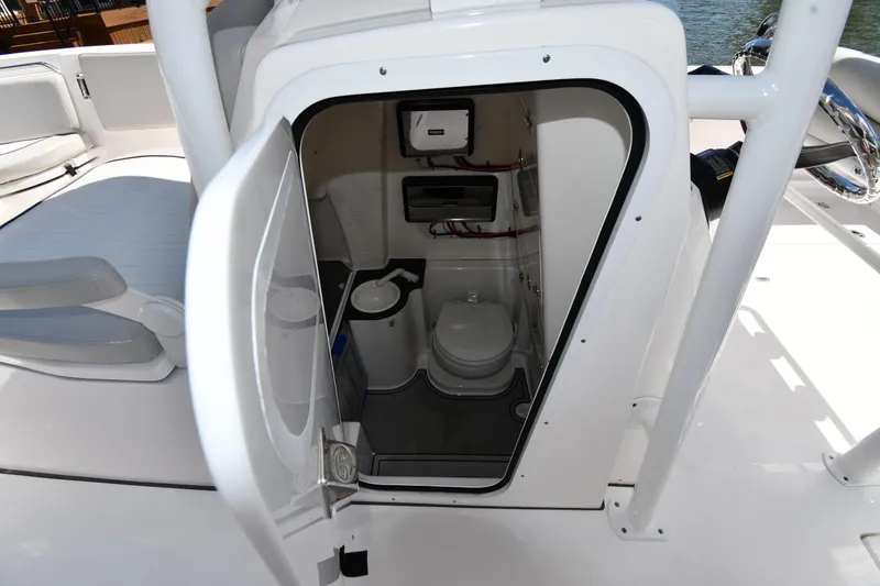 Slide: The Image of 2022 Sea Fox 268 Commander boat interior with open door revealing compact marine toilet. - 44