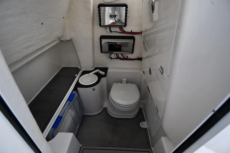 Slide: The Image of 2022 Sea Fox 268 Commander boat bathroom with toilet, sink, and storage compartments. - 45