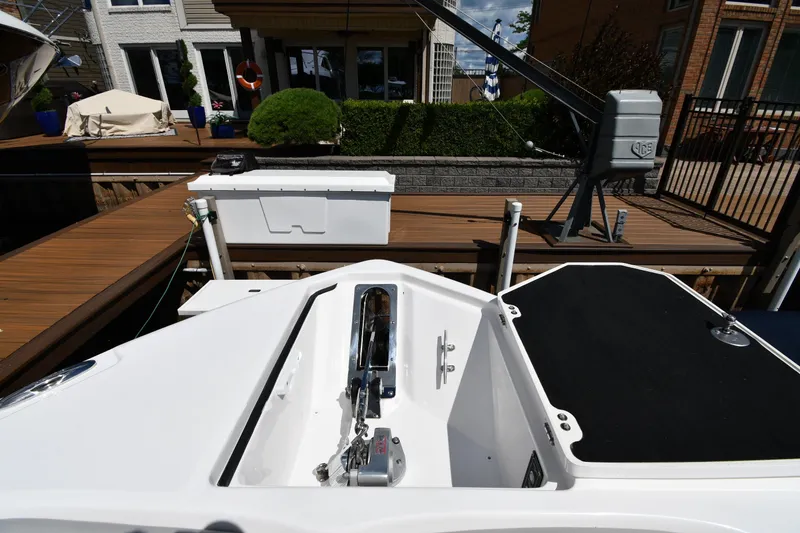 Slide: The Image of 2022 Sea Fox 268 Commander boat docked, showcasing deck and anchor area. - 7