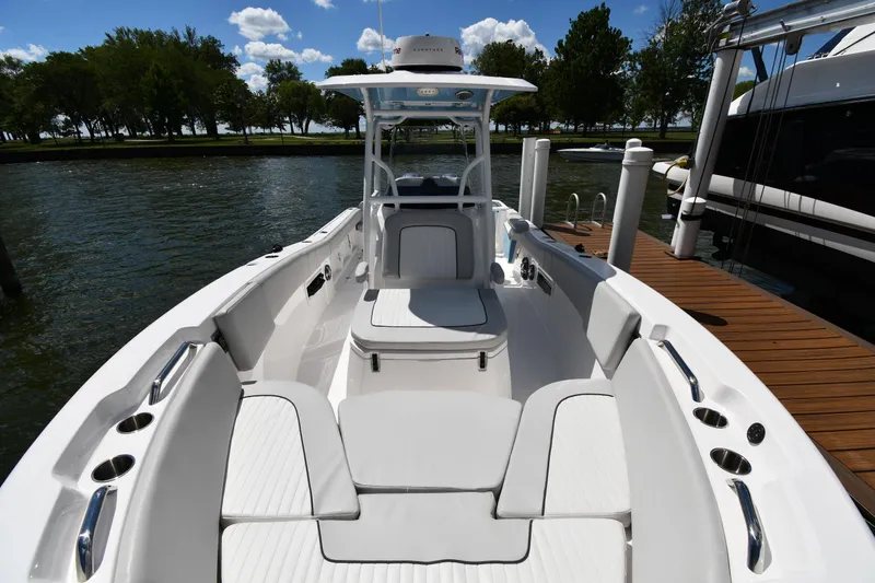 Slide: The Image of 2022 Sea Fox 268 Commander boat docked, featuring spacious seating and sleek design. - 9