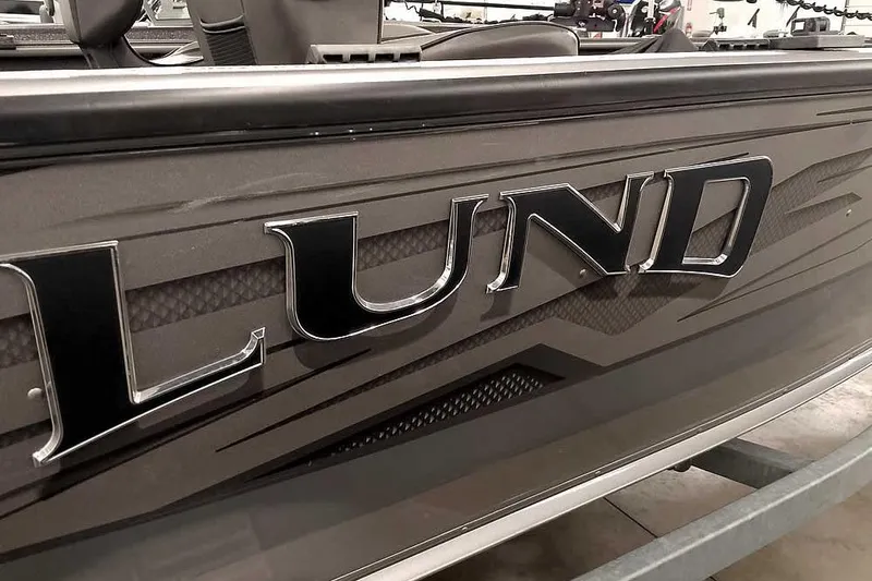 Slide: The Image of 2016 Lund 2075 Pro Guide boat with sleek design and bold logo. - 11