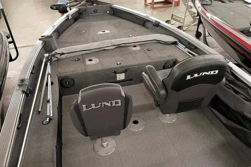 Slide: The Image of 2016 Lund 2075 Pro Guide boat interior with seating and storage compartments. - 18