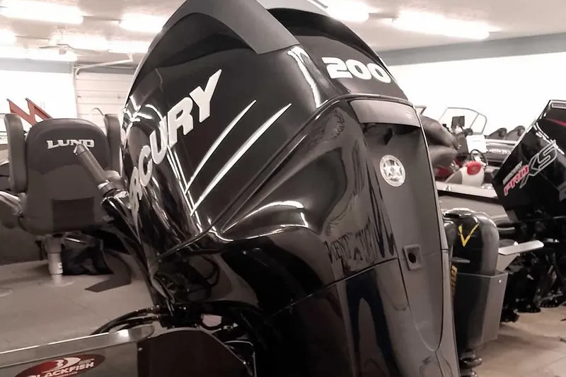 Slide: The Image of 2016 Lund 2075 Pro Guide with Mercury 200 outboard motor in showroom. - 2