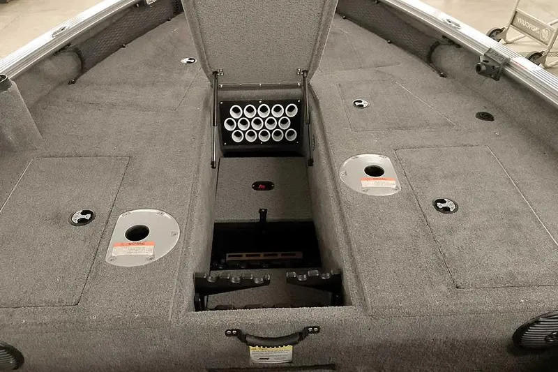 Slide: The Image of 2016 Lund 2075 Pro Guide boat interior with storage compartments and rod holders. - 20