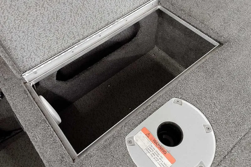 Slide: The Image of 2016 Lund 2075 Pro Guide boat storage compartment with warning label. - 24