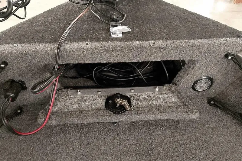 Slide: The Image of 2016 Lund 2075 Pro Guide boat interior wiring and storage compartment. - 27