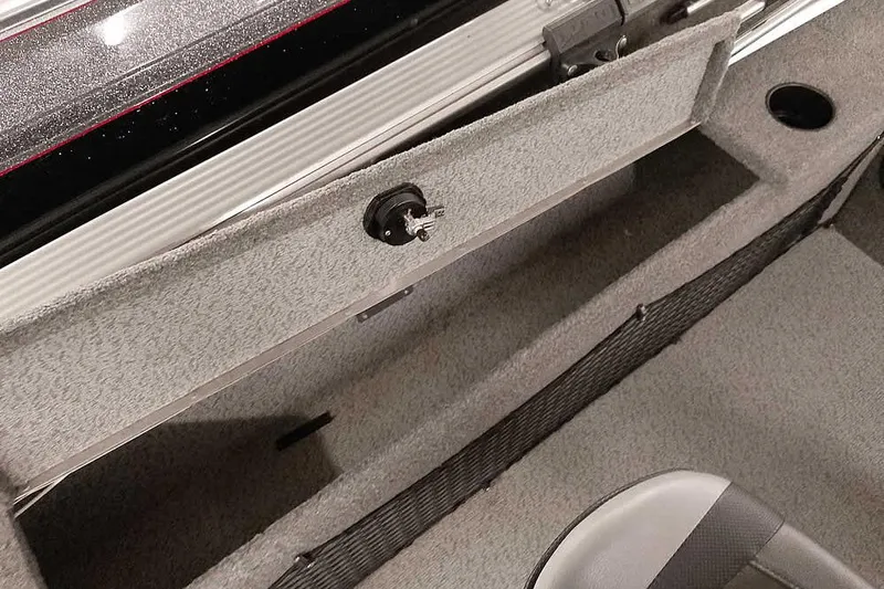 Slide: The Image of 2016 Lund 2075 Pro Guide boat interior storage compartment with carpeted finish. - 29