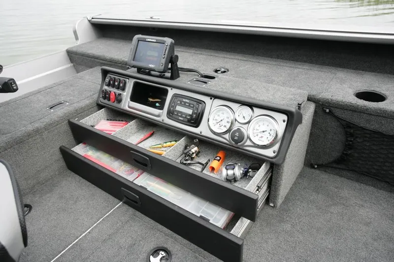 Slide: The Image of Manufacturer Provided Image: 2016 Lund 2075 Pro Guide boat dashboard with storage drawers and fishing equipment. - 34