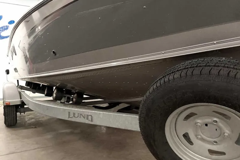 Slide: The Image of 2016 Lund 2075 Pro Guide boat on trailer, close-up view of hull and wheel. - 5