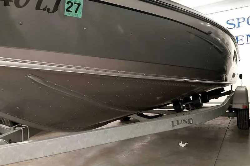 Slide: The Image of 2016 Lund 2075 Pro Guide boat on trailer, close-up view of hull. - 6
