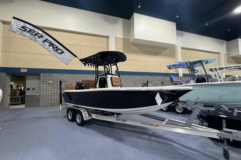 Slide: The Image of 2026 Sea Pro 202 Center Console boat displayed indoors on a trailer. - 1
