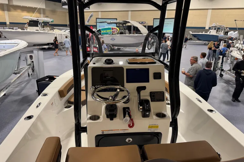 Slide: The Image of 2026 Sea Pro 202 Center Console boat interior at a boat show, featuring modern controls. - 10