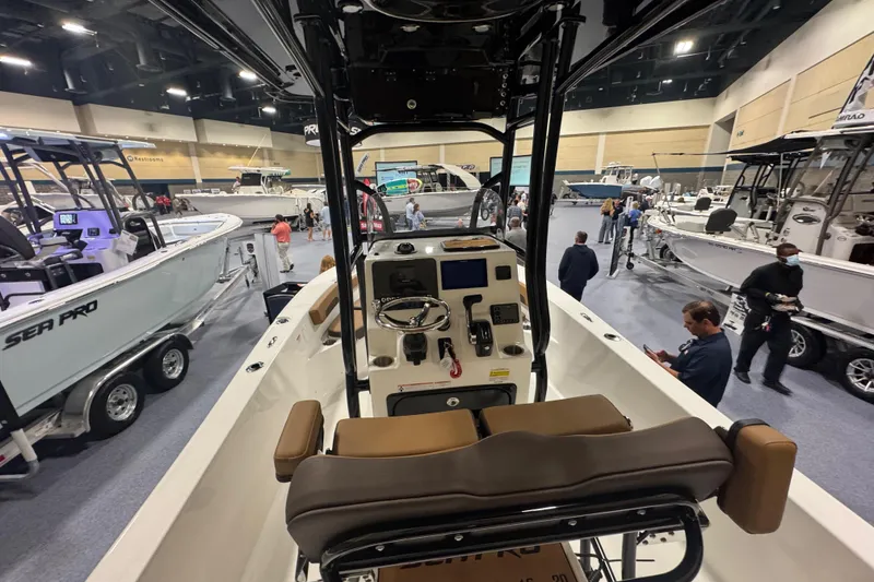 Slide: The Image of 2026 Sea Pro 202 Center Console boat displayed at an indoor boat show. - 11