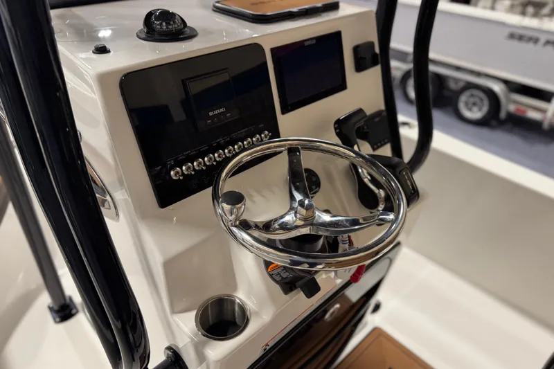 Slide: The Image of 2026 Sea Pro 202 Center Console boat dashboard with steering wheel and controls. - 12