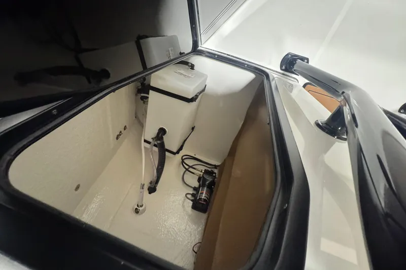 Slide: The Image of 2026 Sea Pro 202 Center Console storage compartment with equipment and wiring. - 17