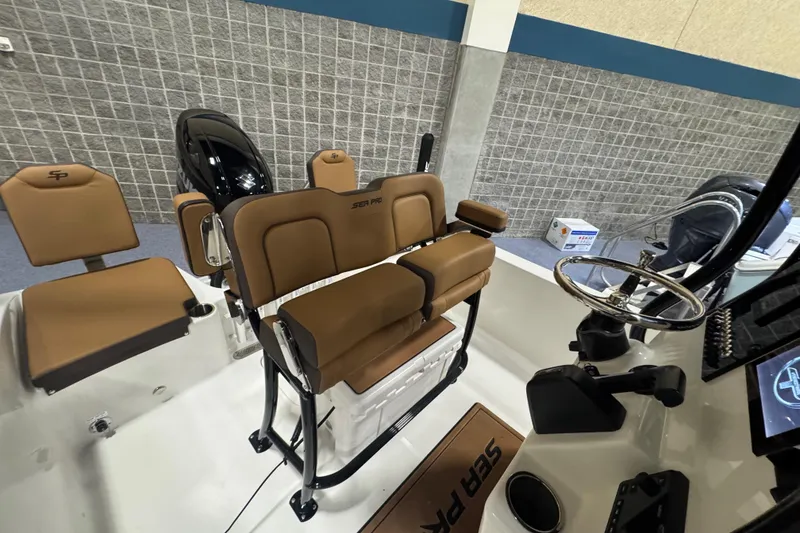 Slide: The Image of 2026 Sea Pro 202 Center Console boat interior with tan seating and steering wheel. - 18
