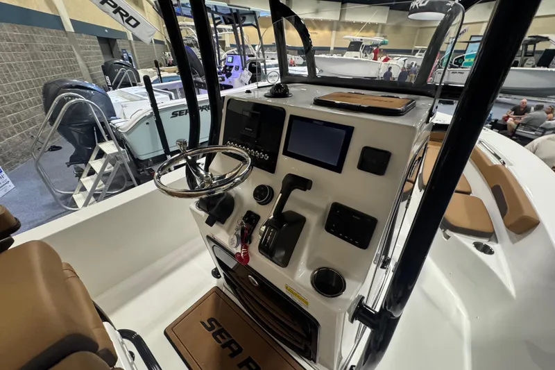 Slide: The Image of 2026 Sea Pro 202 Center Console boat interior with steering wheel and control panel. - 19
