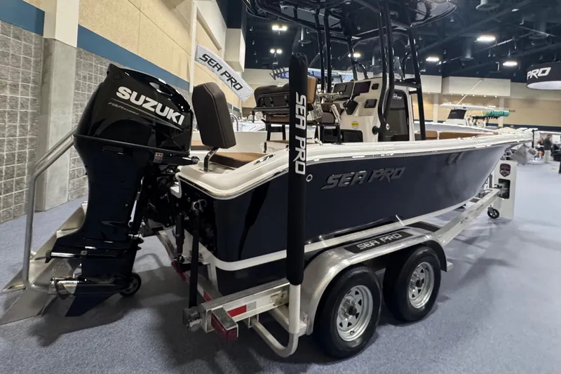 Slide: The Image of 2026 Sea Pro 202 Center Console boat with Suzuki engine on display indoors. - 4