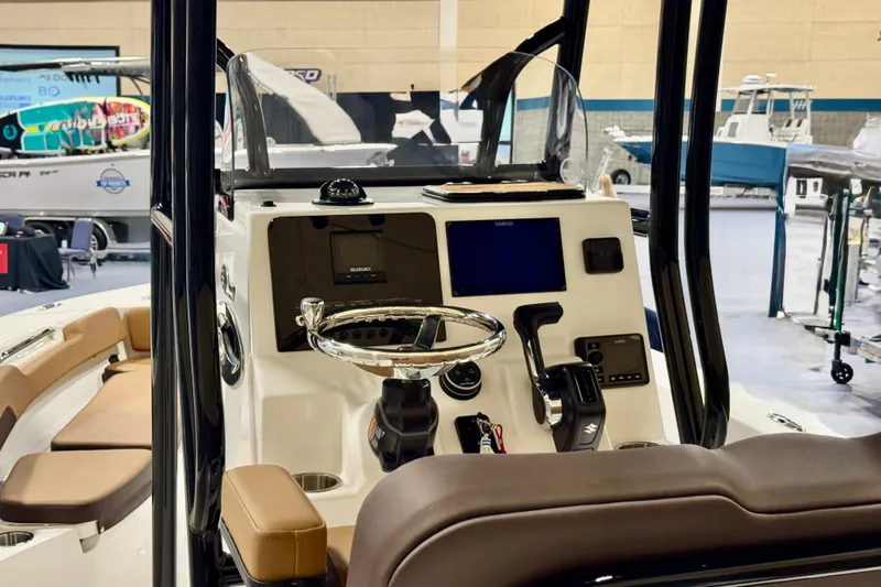 Slide: The Image of 2026 Sea Pro 202 Center Console boat interior with steering wheel and control panel. - 7