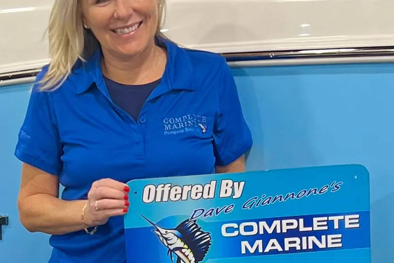 Slide: The Image of Woman holding a sign for Complete Marine, promoting Sea Pro 2026 model boat. - 8