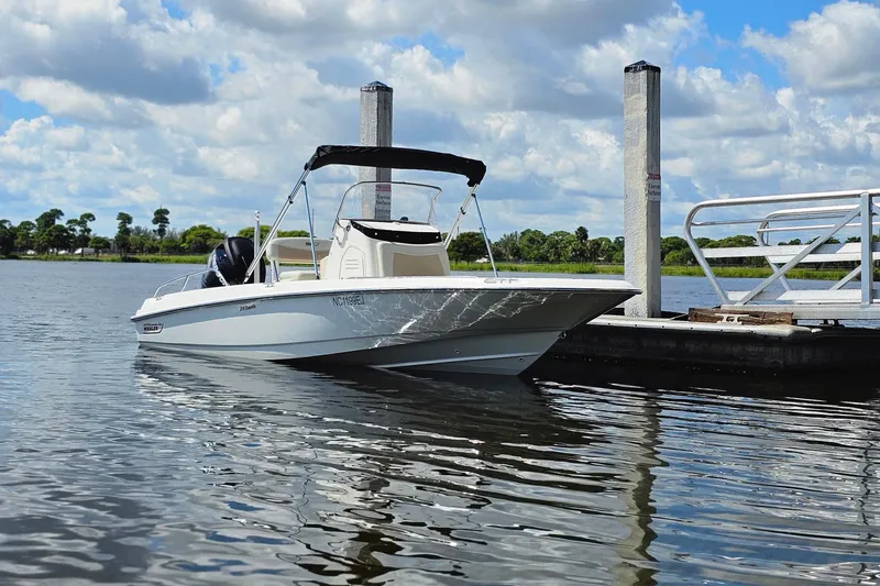 Slide: The Image of 2018 Boston Whaler 210 Dauntless boat docked on a sunny day. - 11