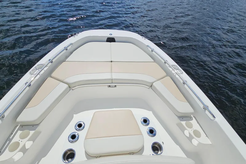 Slide: The Image of 2018 Boston Whaler 210 Dauntless boat interior with cushioned seating and cup holders. - 12