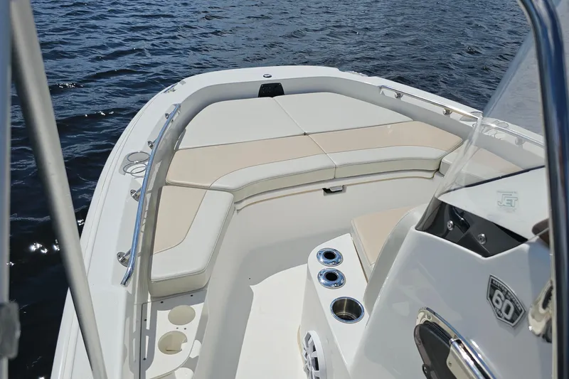 Slide: The Image of 2018 Boston Whaler 210 Dauntless boat interior with cushioned seating and cup holders. - 14