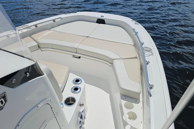 Slide: The Image of 2018 Boston Whaler 210 Dauntless boat interior with cushioned seating on water. - 15