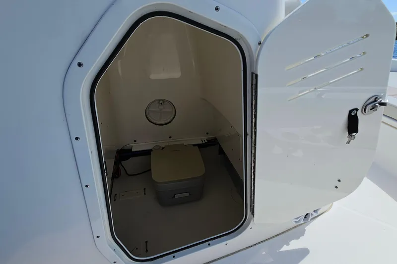 Slide: The Image of 2018 Boston Whaler 210 Dauntless boat storage compartment with open door. - 21