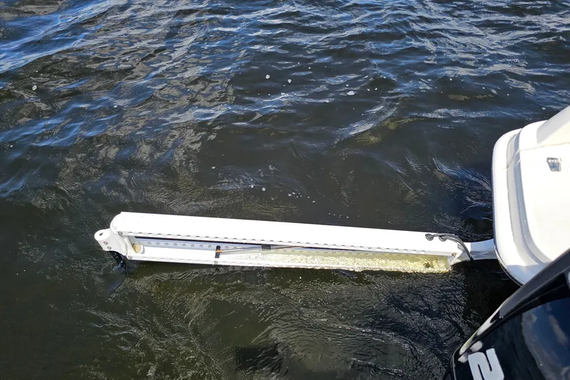 Slide: The Image of 2018 Boston Whaler 210 Dauntless boat with trim tab in water. - 35