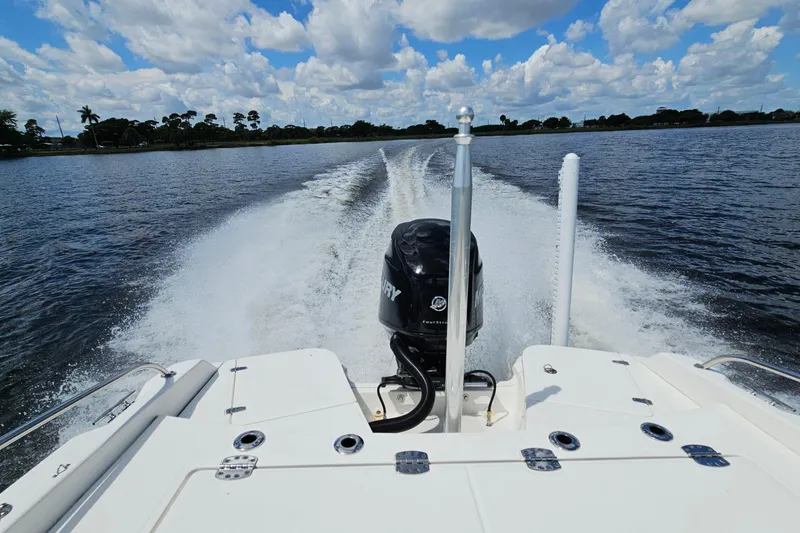 Slide: The Image of 2018 Boston Whaler 210 Dauntless cruising on a lake under a blue sky. - 45