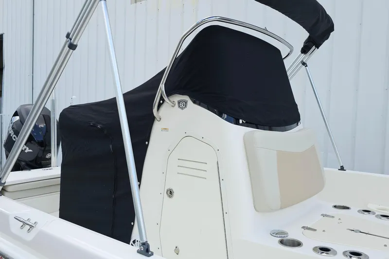 Slide: The Image of 2018 Boston Whaler 210 Dauntless boat with black cover and stainless steel frame. - 47