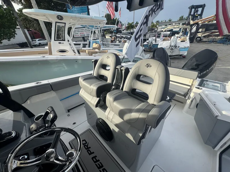 Slide: The Image of 2026 Sea Pro 292 DLX boat interior with dual captain's chairs and steering wheel. - 10