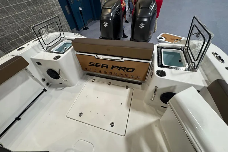Slide: The Image of 2026 Sea Pro 292 DLX boat interior with open compartments and dual engines. - 113
